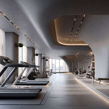 Boxe Devialet Phantom Ultimate Deep Forest montate pe suporturi de perete într-o sală de fitness